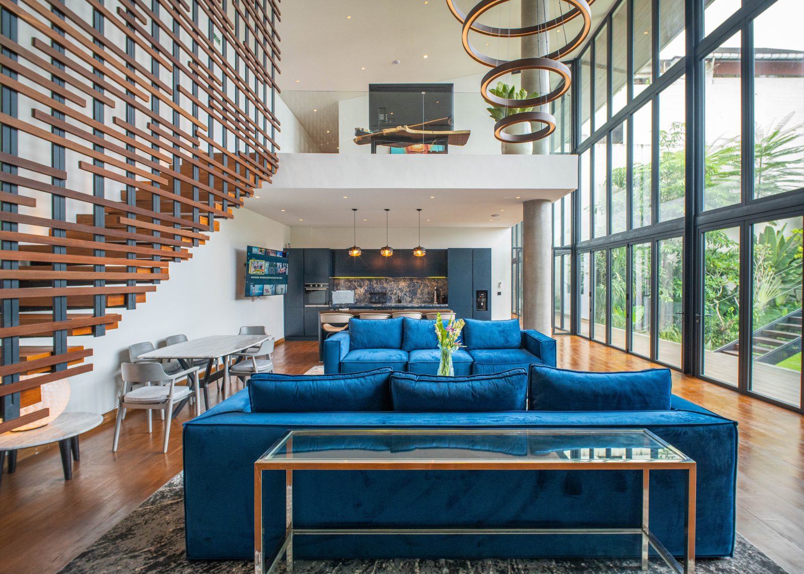 A living area at The Lilly Pad luxury villa with teak flooring and stairs going up to the terrace