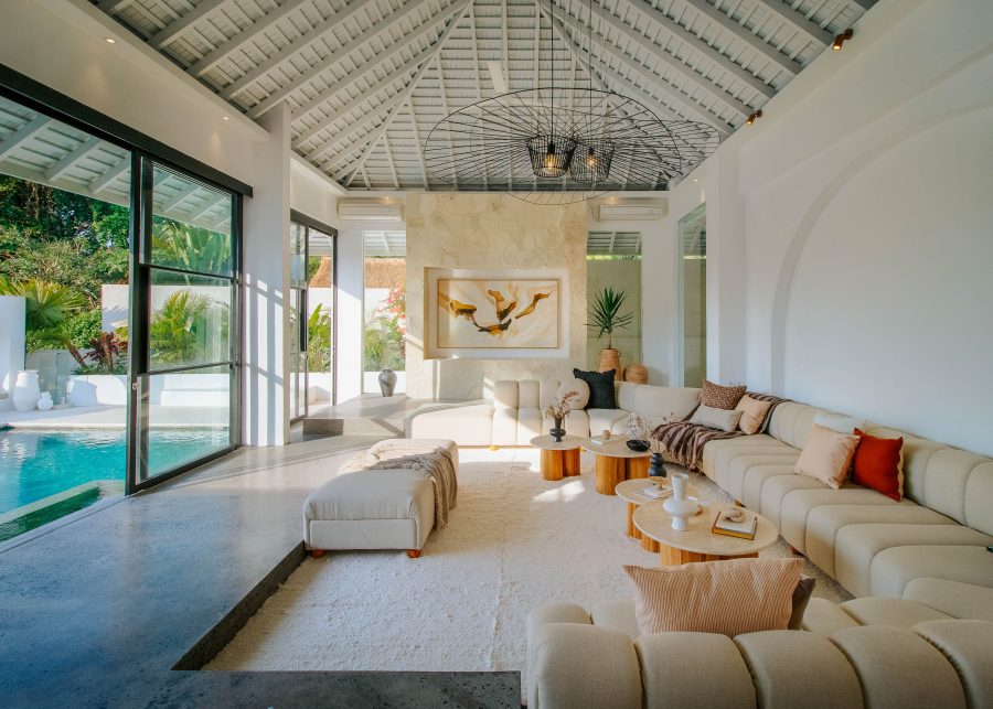 Indoor lounge area at Villa Yang with view of garden and pool through installed glass sliding doors