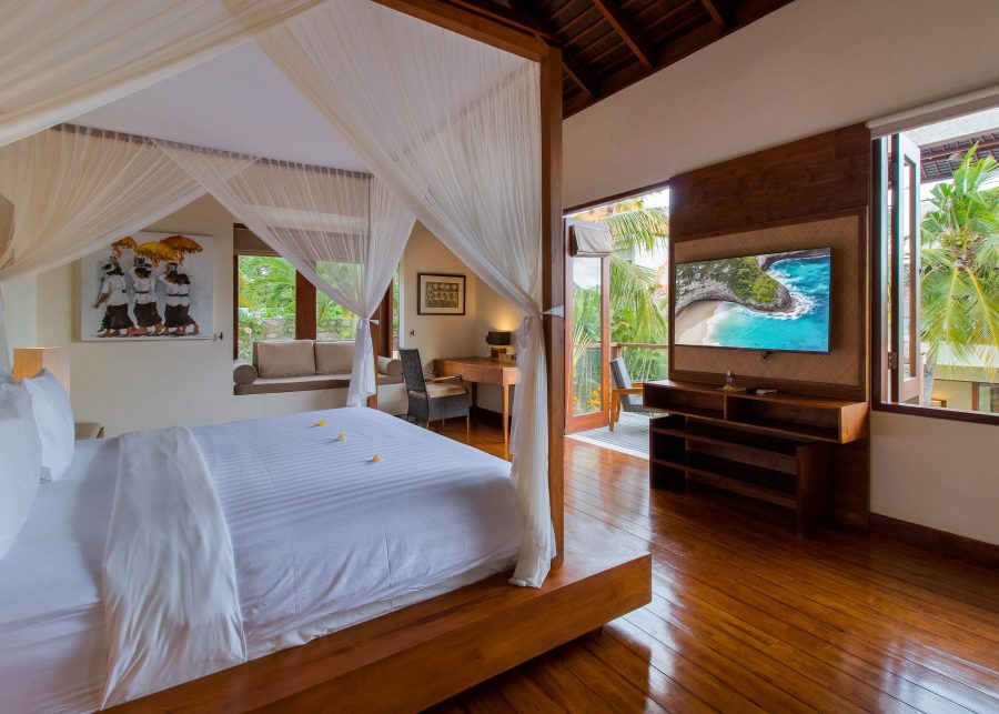 Large bedroom at Villa Josuloma with wooden floors and large television