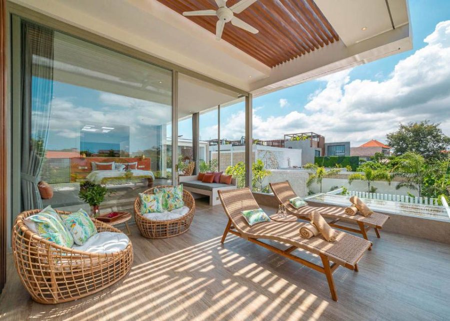 The rooftop terrace of Villa Vida with rattan seating and wooden sunloungers