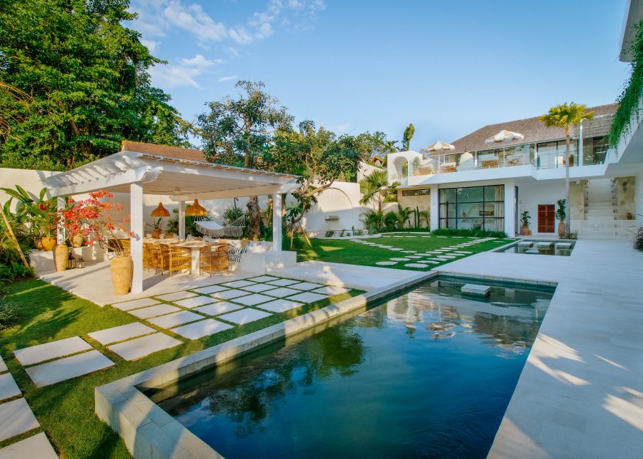 View of pool, manicured garden and outdoor terrace at Villa Yang