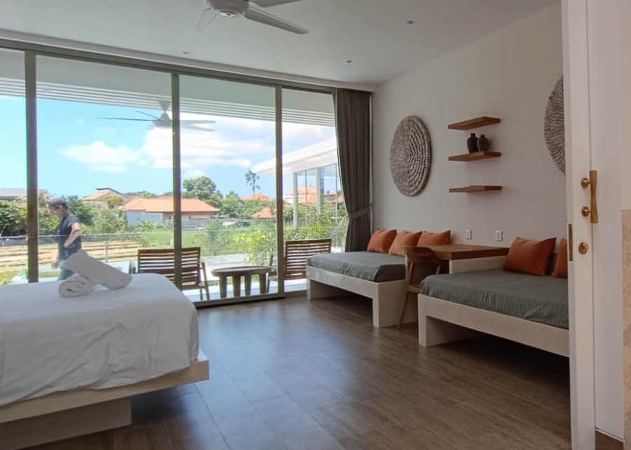 Villa Vida bedroom with two daybeds and scenic view through sliding glass doors