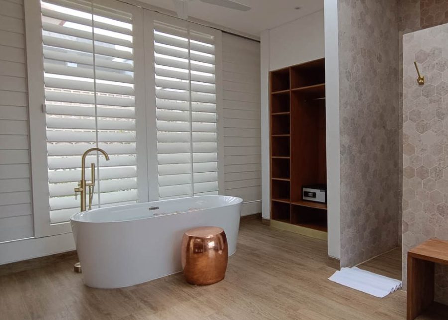 Villa Vida's bathroom with freestanding bathtub and wooden flooring